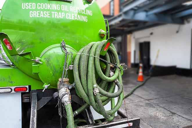 a grease trap being pumped by a sanitation technician in Pepper Pike, OH